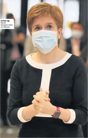  ??  ?? Cover-up Nicola Sturgeon takes no chances