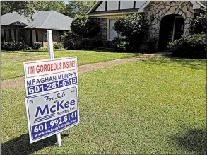  ?? AP file photo ?? Long-term mortgage rates fell this week, but are still squeezing some buyers out of the market for homes like this one for sale in September in Jackson, Miss.