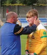  ??  ?? Mick has a few inspiring words for substitute goalkeeper James Walshe after the final whistle in Aughrim.