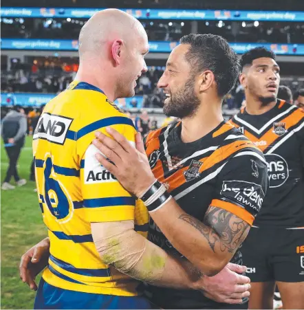  ?? Picture: GETTY IMAGES ?? Benji Marshall (right) embraces Eels rival David Gower after his 300th NRL game last night.