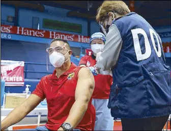  ?? BOY SANTOS ?? San Juan Mayor Francis Zamora gets his first dose of Sinovac Biotech’s COVID-19 vaccine at the FilOil Flying V Center yesterday.