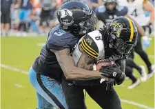  ?? JOHN E. SOKOLOWSKI GETTY IMAGES FILE PHOTO ?? Jamal Peters, then of the Argonauts, tackles Steven Dunbar Jr. of the Hamilton Tiger-Cats after a pass reception at BMO Field in Toronto in August 2022. Peters will be suiting up for the Ticats this season.