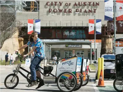  ?? Ralph Barrera photos/Austin American-Statesman via AP ?? left
Rob Cross parks his electric-assisted vehicle pedicab on Tuesday in Austin. Some Austin pedicabs are getting a boost just in time for the spring festival season by installing electric motors as part of a new city pilot program. Austin...