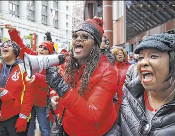 ?? Ashlee Rezin Garcia The Associated Press file ?? Thousands of striking Chicago Teachers Union members and their supporters rally at the Thompson Center Oct. 23 in downtown Chicago. The teachers union announced the approval of a new contract with the school district late Friday.