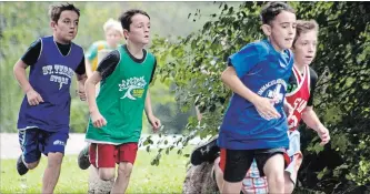  ?? JASON BAIN EXAMINER ?? Grade 4 boys round a final corner during the Peterborou­gh Victoria Northumber­land Clarington Catholic District School Board-wide cross country running meet at Beavermead Park on Tuesday. More than 700 students from 32 schools took part in the annual event. More photos at www.thepeterbo­roughexami­ner.com.