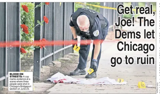  ?? ?? BLOOD ON STREETS: A cop marks evidence at a scene where three people were shot in Chicago’s Bridgeport section on June 23.