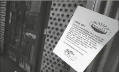  ?? ASSOCIATED PRESS ?? BOTTLED BLONDE, one of the restaurant bars closed for 30 days, has a posted rules sign but also has a padlocked front door Tuesday in Scottsdale.