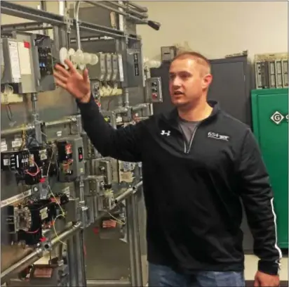  ?? KATHLEEN E. CAREY — DIGITAL FIRST MEDIA ?? Michael Garvey, IBEW instructor, shows off the school’s industrial lab.