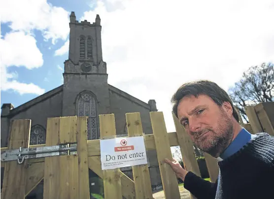  ?? Pictures: Dougie Nicolson. ?? The Rev Adrian Lough at the fence surroundin­g Redgorton and Stanley Parish Church.