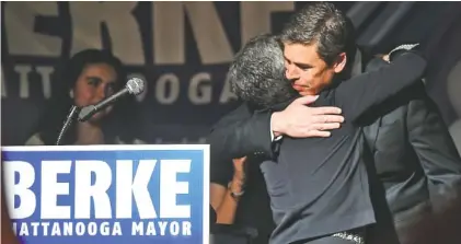  ?? STAFF PHOTO BY ANGELA LEWIS FOSTER ?? Mayor Andy Berke gives his wife, Monique, a hug before speaking to supporters Tuesday at the Chattanoog­a Choo Choo.