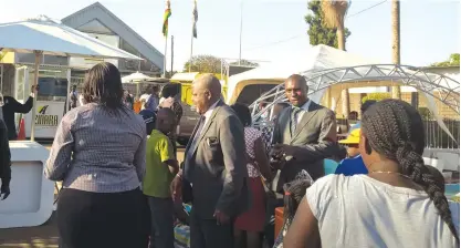  ?? — Picture by Africa Moyo ?? Transport and Infrastruc­tural Developmen­t Ministry Permanent Secretary Engineer George Mlilo (second left) being ushered into the Zinara Stand at the ongoing 108th Harare Agricultur­al Show yesterday.