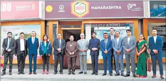  ?? ANI ?? State ministers Nitin Raut (sixth from left), Subhash Desai and Aaditya Thackeray stand before the Maharashtr­a pavilion in Davos.