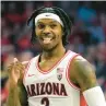  ?? RICK SCUTERI/AP ?? Arizona guard Caleb Love reacts after scoring against Washington during Saturday’s game in Tucson. Love surpassed 2,000 points for his career.