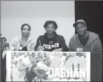  ?? The Sentinel-Record/Richard Rasmussen ?? BUFFALO BACKER: Hot Springs senior Da’Shan Doss, center, was joined by his stepmother Tiffany Doss, left, and his father Virgil Doss Wednesday in the Johnnie Mae Mackey Theatre as he signed to play football at Arkansas Baptist College.