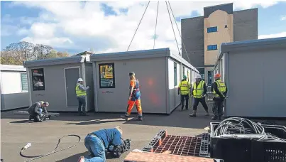  ?? Pictures: SWNS. ?? Cabins are installed in the playground at the Royal High School in Edinburgh. Below: a look inside one of the temporary classrooms.