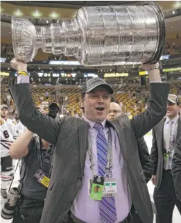  ?? BRUCE BENNETT/GETTY IMAGES ?? Norm Maciver (hoisting the Stanley Cup in 2013) will lead an effort to scout hidden gems who can help the Hawks with their salary-cap pain.