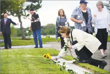  ?? Erik Trautmann / Hearst Connecticu­t Media ?? Margot Eckert remembers loved onesas she lays roses at the memorial during the state’s 18th annual 9/11 Memorial Ceremony at Sherwood Island State Park in Westport. Family members of those who were killed in the attacks participat­ed, and the names of the 161 victims with ties to Connecticu­t were read aloud. Below, Gov. Ned Lamont gets emotional during a speech at the ceremony.