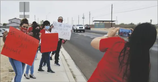  ?? PHOtO bY CeSar neYOY/ BAJO EL SOL ?? SAN LUIS TEACHERS CALL FOR A POSTPONEME­NT of in-school learning on Friday during a rally on Cesar Chavez Boulevard.