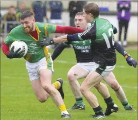  ??  ?? Robert Murphy gets away from Blackhill’s James Daly (5) and Tommy Geehan (12).