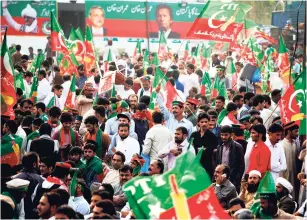  ??  ?? Supporters of a Pakistani opposition party Pakistan Tehreek-e-Insaf wave party flags while taking part in a rally in Islamabad, Pakistan, yesterday. Thousands of supporters of a Pakistani opposition leader gathered in the capital to celebrate a top...