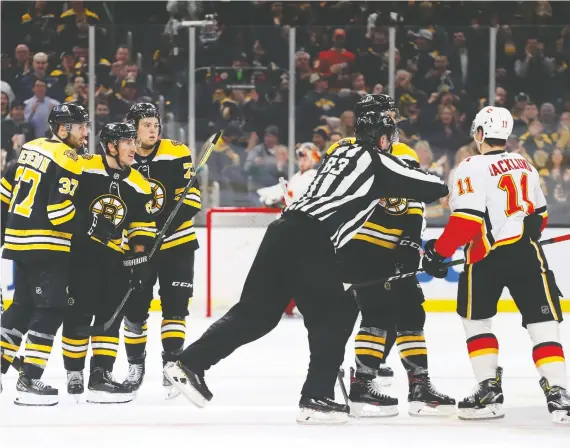  ?? GETTY IMAGES ?? Mikael Backlund, here in a stare-down with Boston agitator Brad Marchand, second from left, has been the Flames’ best player since the all-star break, Wes Gilbertson writes.