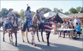  ?? RITA GREENE/MCDONALD COUNTY PRESS ?? Beautiful horses adorned with the red, white and blue of the flag standing before the judges at the Jesse James Days Parade at Pineville Square Aug 10-13.