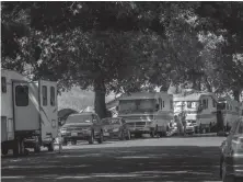  ?? Tribune News Service/the Sacramento Bee ?? Two women refill a motorhome with water on Lathrop Way in Sacramento in 2021. On most days there are at least 95 vehicles belonging to the homeless, who say they have been given no other options but to park their vehicles within the city.