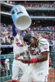  ?? MATT SLOCUM — THE ASSOCIATED PRESS ?? The Phillies’ Maikel Franco, right, is doused by Bryce Harper after Franco hit the game-winning home run during the ninth inning of a baseball game, Sunday in Philadelph­ia.