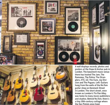  ??  ?? A wall displays records, photos and posters at the Hope & Anchor pub in London. The basement music venue there has hosted The Jam, The Ramones, The Police, The Stranglers, XTC, U2, The Cure, Joy Division and The Pogues. Left: Guitars hang from the...