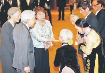  ??  ?? Emperor Akihito and Empress Michiko meet with family members of Japanese veterans living in Vietnam, at a hotel in Hanoi, Vietnam. — Reuters photo