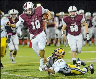  ?? DANA JENSEN/ THE DAY ?? East Lyme’s Blane Hart (10) is tripped up by Ledyard’s Brenden Thornton (14) during Friday night’s game at East Lyme. Hart scored four touchdowns as the Vikings rolled to a 42-12 win. Visit theday. com to view a photo gallery.