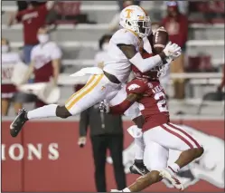  ?? (NWA Democrat-Gazette/Charlie Kaijo) ?? Arkansas defensive back LaDarrius Bishop (right) breaks up a pass intended for Tennessee wide receiver Brandon Johnson during the second quarter of Saturday night’s game at Reynolds Razorback Stadium in Fayettevil­le.