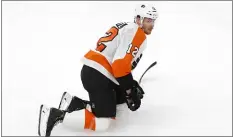  ?? CHARLES REX ARBOGAST – THE ASSOCIATED PRESS ?? Flyers left wing Michael Raffl stays on the ice after injuring his right leg during the third period Thursday against the Blackhawks in Chicago. The Flyers won the game 4-1.