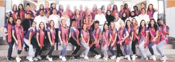  ?? ?? Syeed Mohd Hussien (sixth second row), Ooi (seventh second row) in a photo call with the Miss Tourism Internatio­nal contestant­s in front of Centexs Lundu campus.