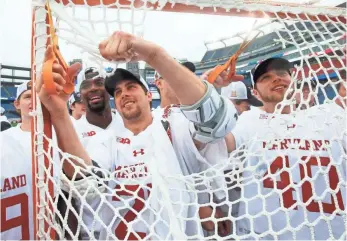  ?? WINSLOW TOWNSON, USA TODAY SPORTS ?? Dylan Maltz, left, and Connor Kelly cut the netting after Maryland’s 9-6 win against Ohio State.