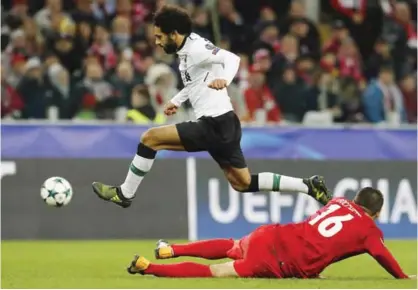  ??  ?? MOSCOW: Liverpool’s Mohamed Salah, top, jumps over Spartak’s Salvatore Bocchetti during the Champions League soccer match between Spartak Moscow and Liverpool in Moscow, Russia, yesterday. — AP