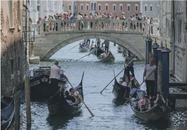  ?? GETTY IMAGES ?? More than 15,000 visitors have bought tickets to enter the popular Italian city of Venice on April 25 – the first of 29 days this year when day-trippers must pay to get in. The city is hoping the scheme will help reduce the hordes of tourists clogging its streets and canals.