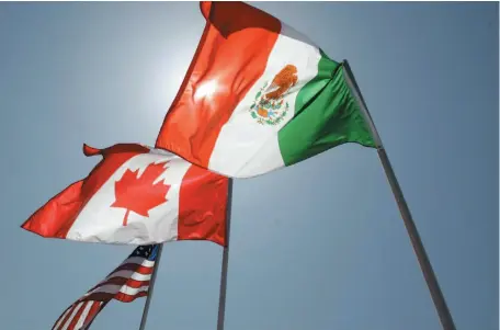  ?? AP FILE PHOTO ?? National flags of the United States, Canada and Mexico fly in the breeze in New Orleans. The Canadian government may have been left out of NAFTA talks between the U.S. and Mexico last week and again this week – but federal insiders insist they’re...