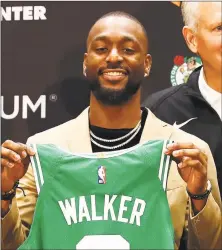  ?? Tim Bradbury / Getty Images ?? Kemba Walker is introduced as a member of the Boston Celtics during a press conference Wednesday in Boston.