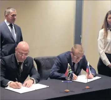  ??  ?? Stavros Nicolaou, Aspen senior executive (left) and Professor Yury Khotimchen­k of the Far Eastern Federal University of Russia, sign a collaborat­ion agreement, while deputy president of the Russian Republic, Yury Trutnev, looks on.