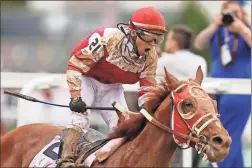  ?? Silas Walker/Lexington Herald-Leader/TNS ?? Rich Strike, with Sonny Leon up, wins the 148th running of the Kentucky Derby at Churchill Downs on Saturday, May 7.