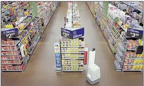  ?? Special to the Democrat-Gazette ?? A robot prowls the aisles of a Wal-Mart store in a test run of the autonomous device’s “mission” to check shelves and alert workers to stocking or pricing needs.