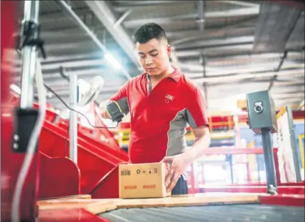  ?? PROVIDED TO CHINA DAILY ?? An employee scans a parcel in JD’s distributi­on center in Xi’an, Shaanxi province.