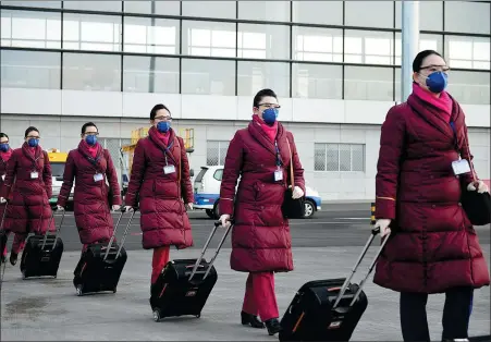  ?? PHOTOS PROVIDED TO CHINA DAILY ?? Crew members of China Southern Airlines make their way to work.