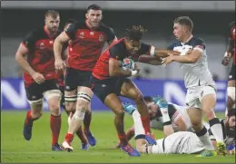  ?? The Associated Press ?? TACKLING ENGLAND: England’s Anthony Watson is tackled by United States’ Ruben de Haas, right, a Jessievill­e graduate, during Thursday’s Rugby World Cup Pool C game at Kobe Misaki Stadium in Kobe, Japan.