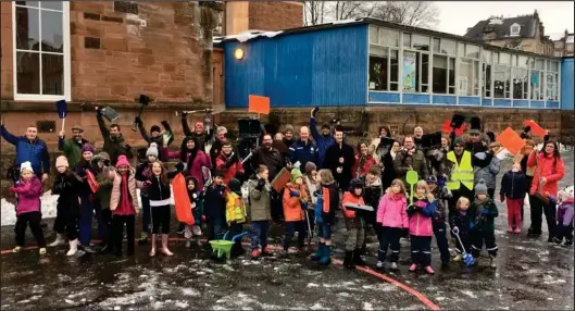  ??  ?? Proud parents and pupils work hard to clear Battlefiel­d Primary ahead of the school reopening, after last week’s shutdowns due to the heavy snow