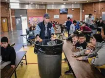  ?? ?? Students dispose of their unfinished food at the end of lunch break at V. H. Lassen Academy of Science and Nutrition in Phoenix on Jan. 31.