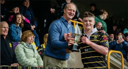  ?? ?? Neil Conaghan, Chief Executive Officer, GoFibre presents Melrose captain the Drummond Cup as the team clinch victory against Kelso in the U16s youth tournament at Melrose Sevens