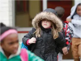  ?? (Photo by John Fitzhugh, The Sun Herald via AP) ?? North Bay Elementary School student Vivian Moore, 7, of Biloxi, Miss., braces against the cold weather as she walks to her bus after school on Wednesday, Dec., 6, 2017. Forecaster­s say conditions could be right for snowfall in South Mississipp­i late...