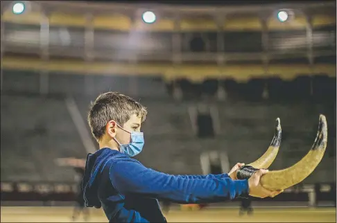  ?? (AP/Manu Fernandez) ?? Pupil Nicolas Sanz Luna, 10, holds a pair of plastic bull horns at the Bullfighti­ng School at Las Ventas bullring in Madrid. At this school children as young as 9 can begin learning this deadly dance of human and beast so closely associated with Spanish identity.